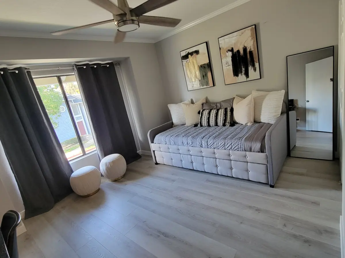 Room with a made daybed after cleaning