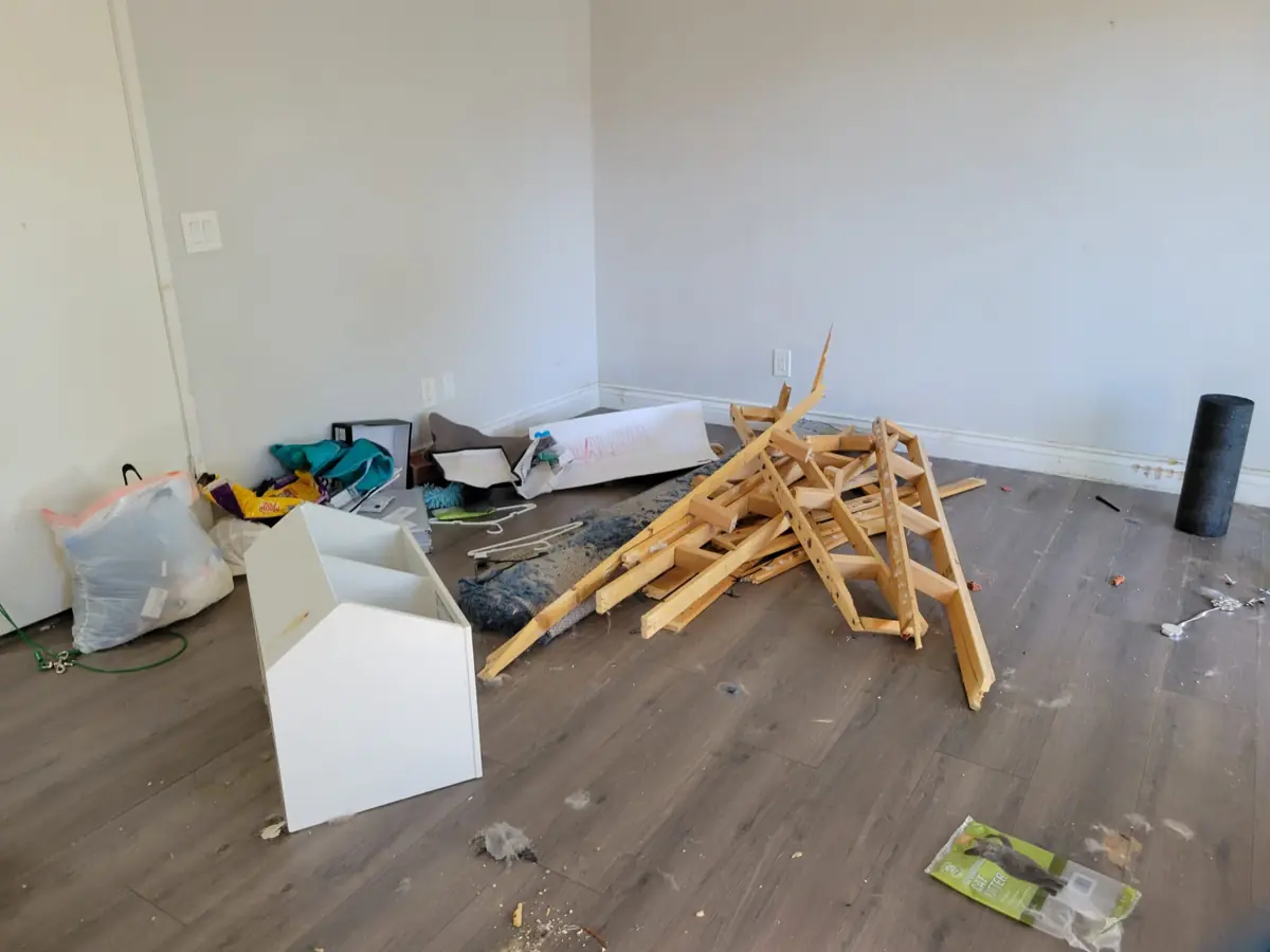 Room with leftover lumber and debris before a post-construction cleaning in Santa Ana