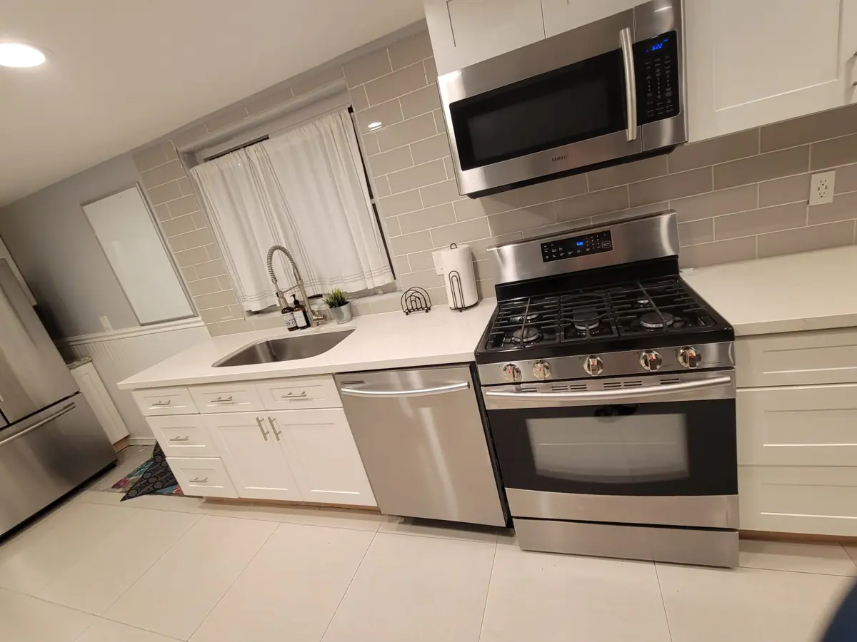 White kitchen with stainless appliances after cleaning
