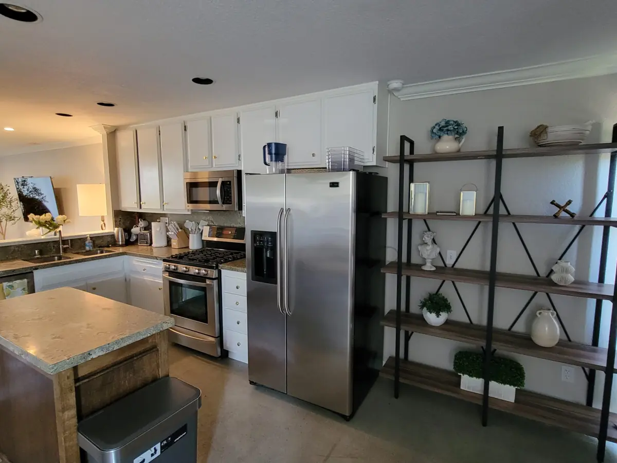 Kitchen with stainless fridge and shelves after cleaning