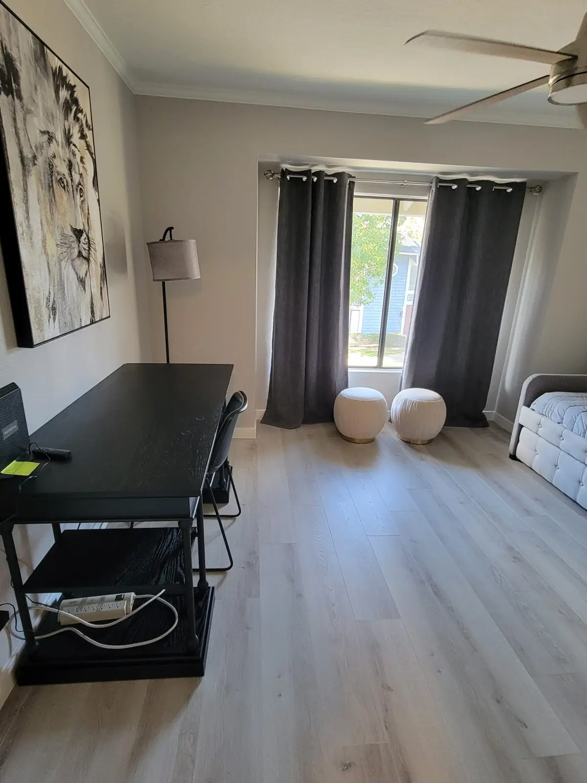 Room with a curtained window and clean floors