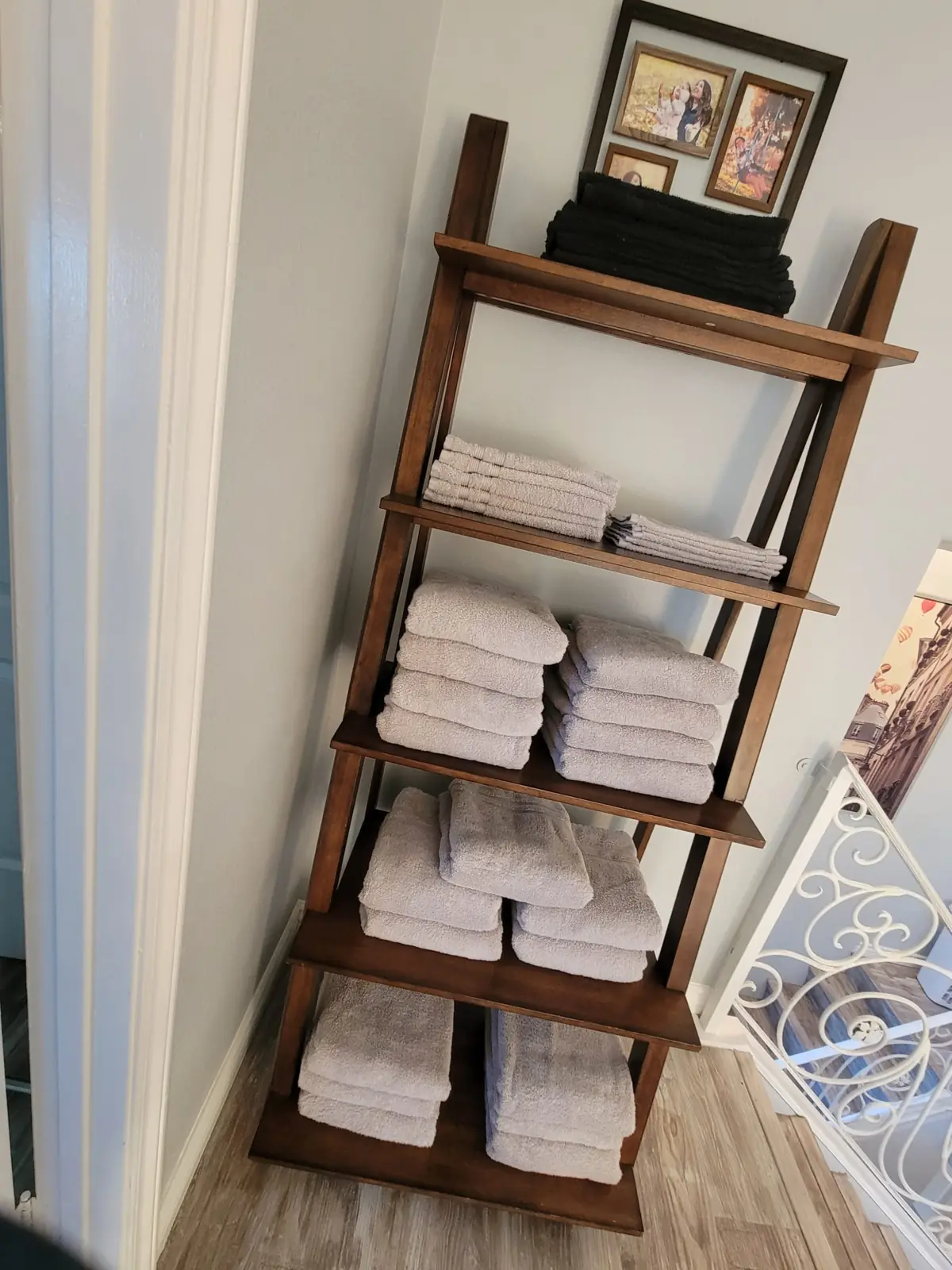 Shelf with folded white towels in a rental